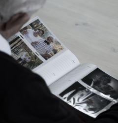 old man flicking through a photo album