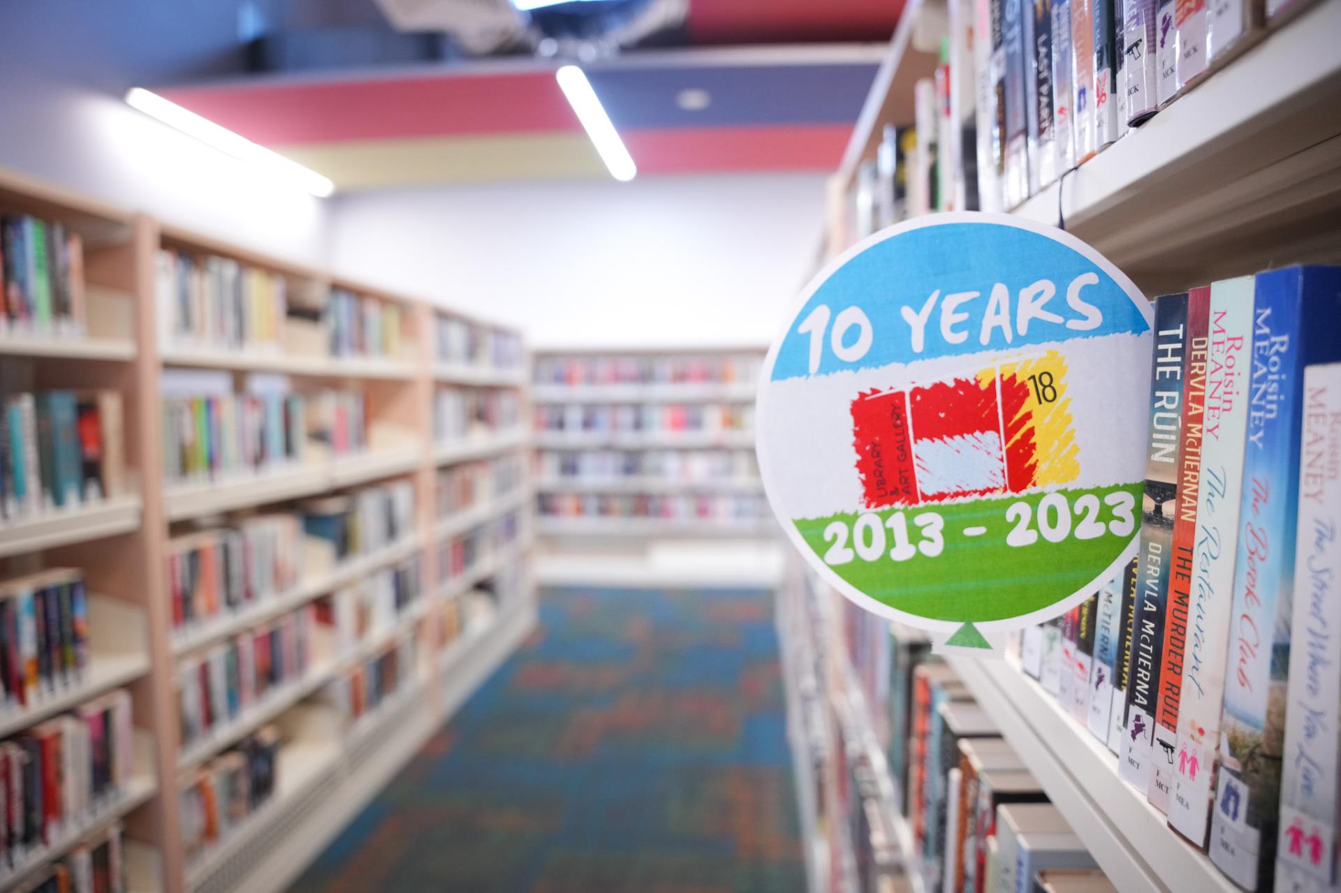 library shelves with 10th anniversary balloon